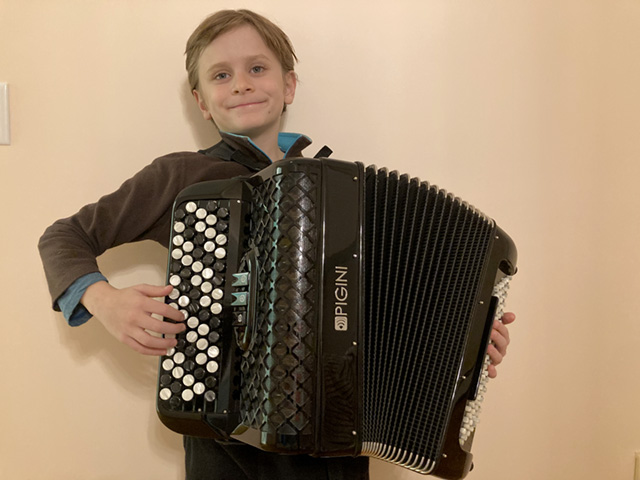A drawing by a pre-k student of two hearts and a hand