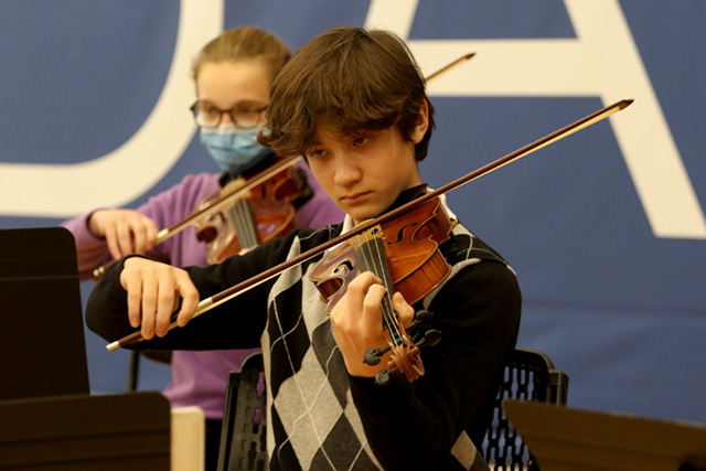 A drawing by a pre-k student of two hearts and a hand