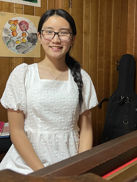 A drawing by a pre-k student of two hearts and a hand